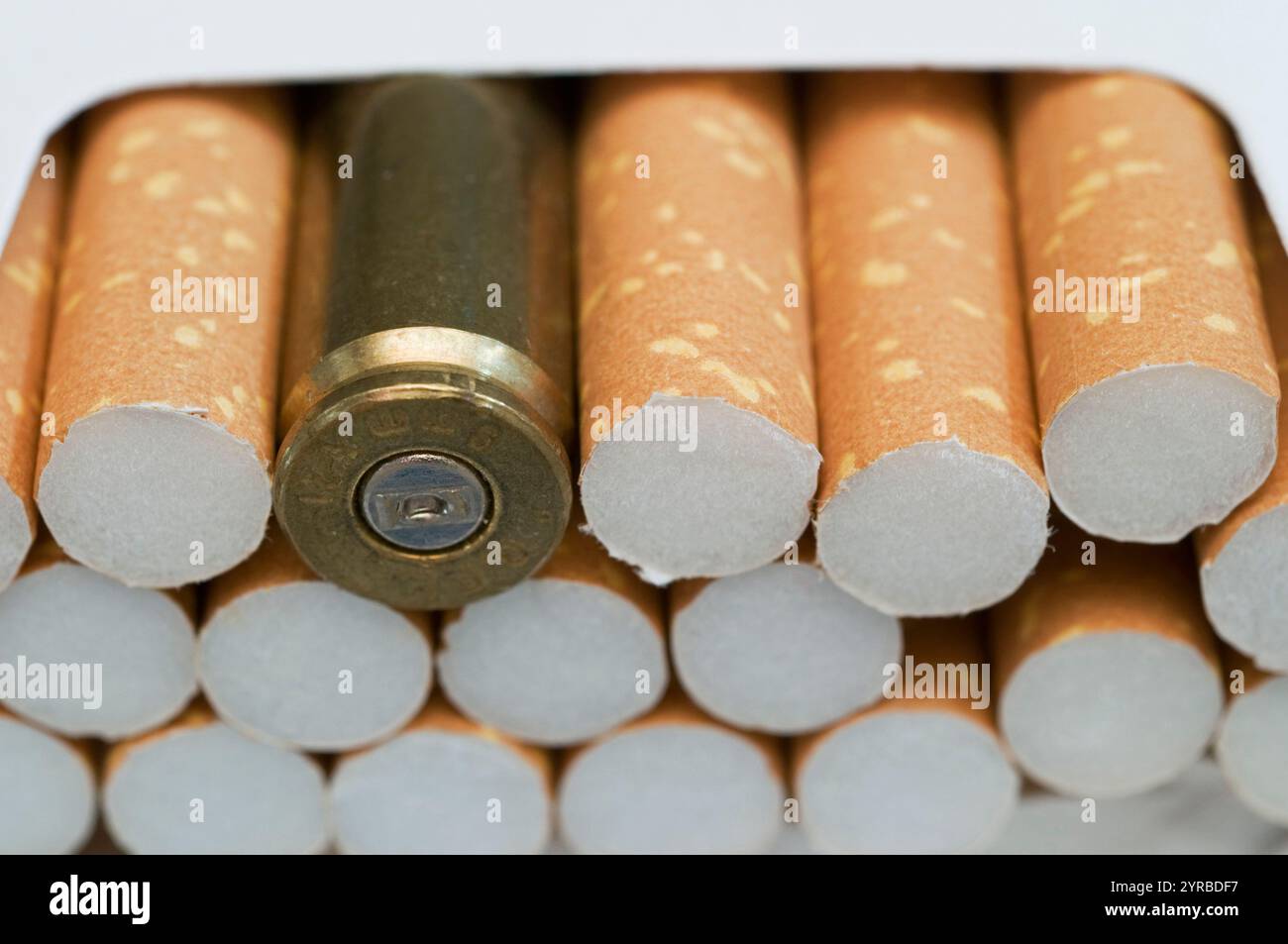 Bullet in cigarette box Stock Photo - Alamy