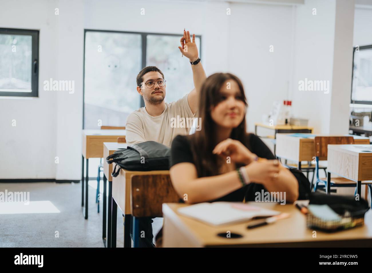 Engaged high school students participating actively in a classroom setting Stock Photo