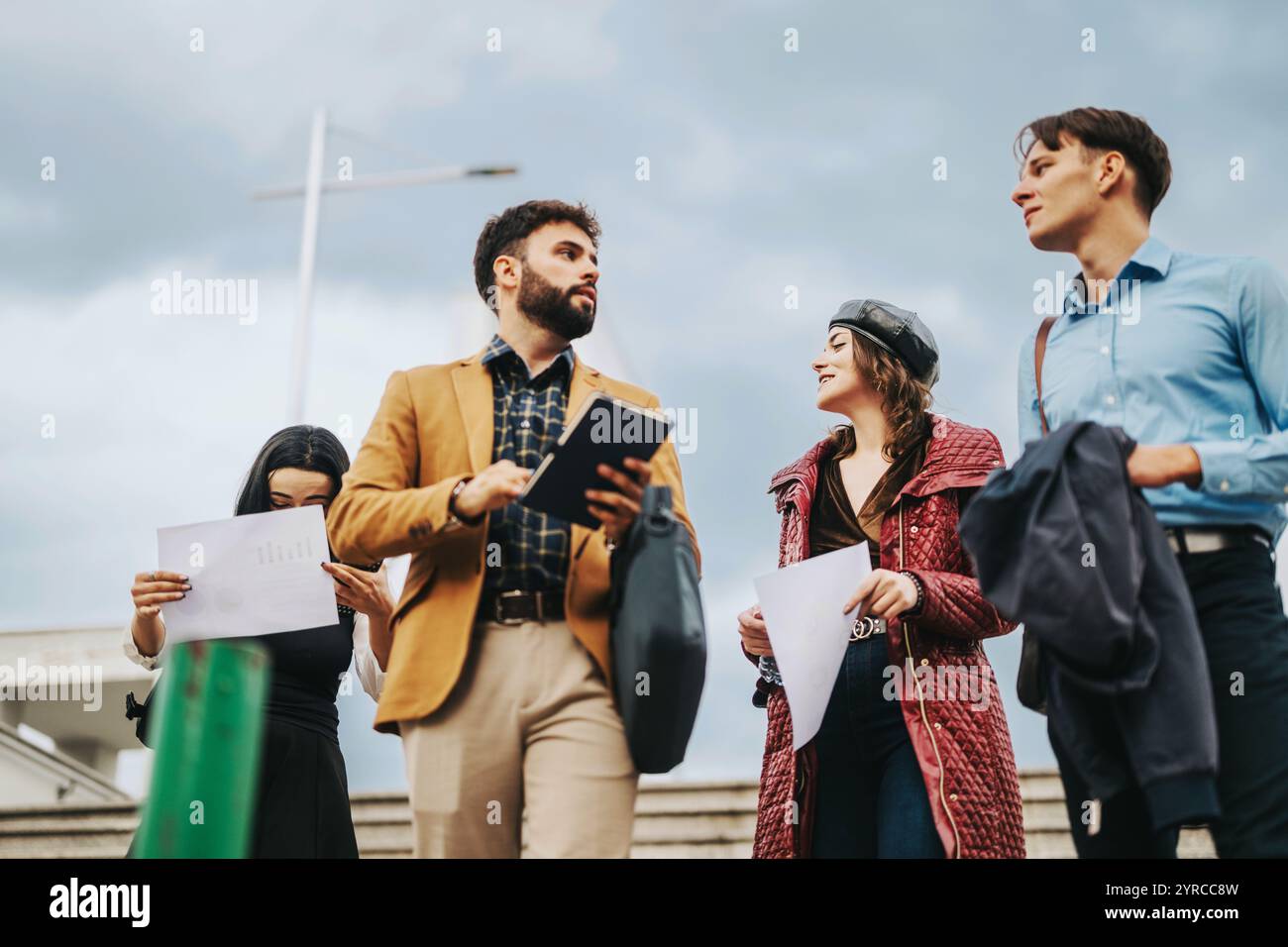 Group of business people walking in urban city environment Stock Photo ...