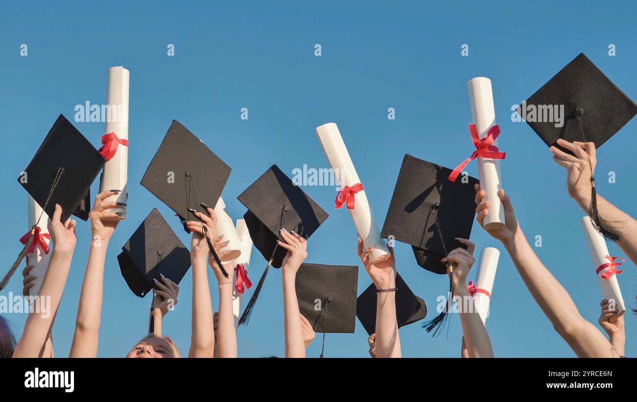 Happy graduates throwing graduation hats and diplomas in the air Stock ...