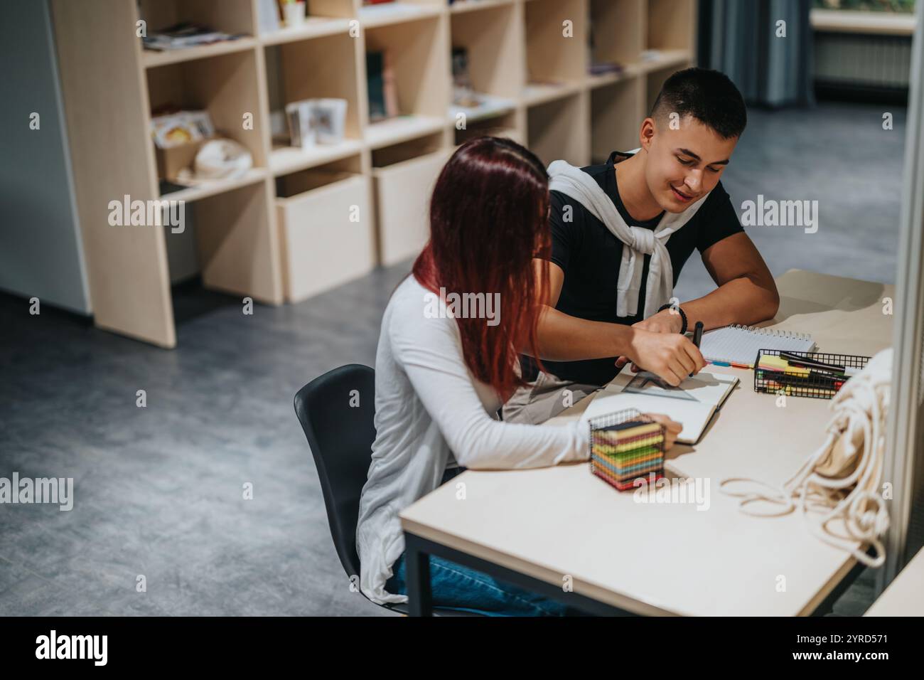 Students collaborating on a study project in a school library Stock Photo