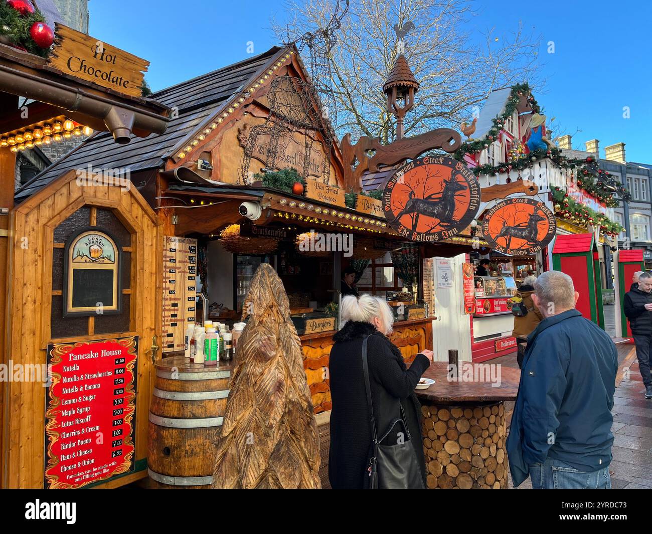 German Style Christmas Market on Working Street next to St John's Church. Cardiff, Wales, United Kingdom. 26th November 2024. - Smartphone Captured Stock Image
