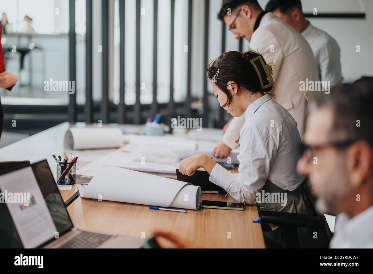 Diverse team of people collaborating in modern office environment Stock ...