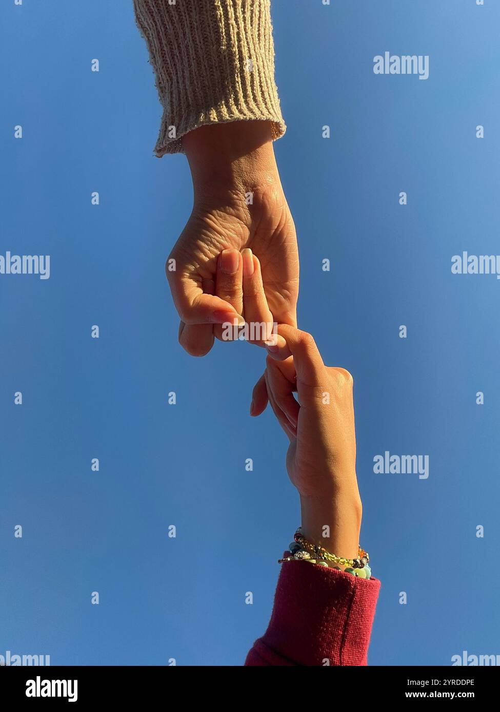 A moment of connection under the endless sky. Trust, love, and unity captured in a single touch. - Smartphone Captured Stock Image