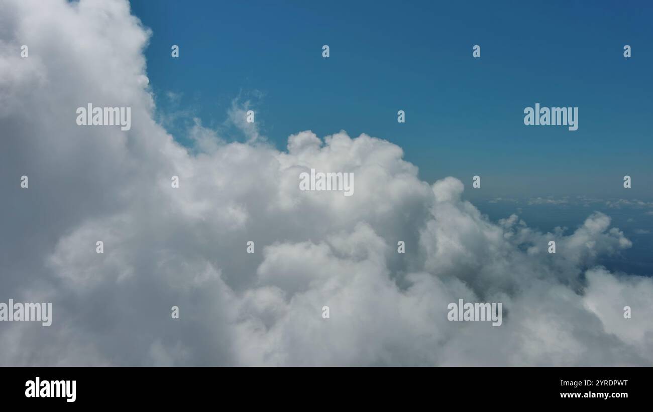 Flying through white fluffy clouds Stock Photo - Alamy