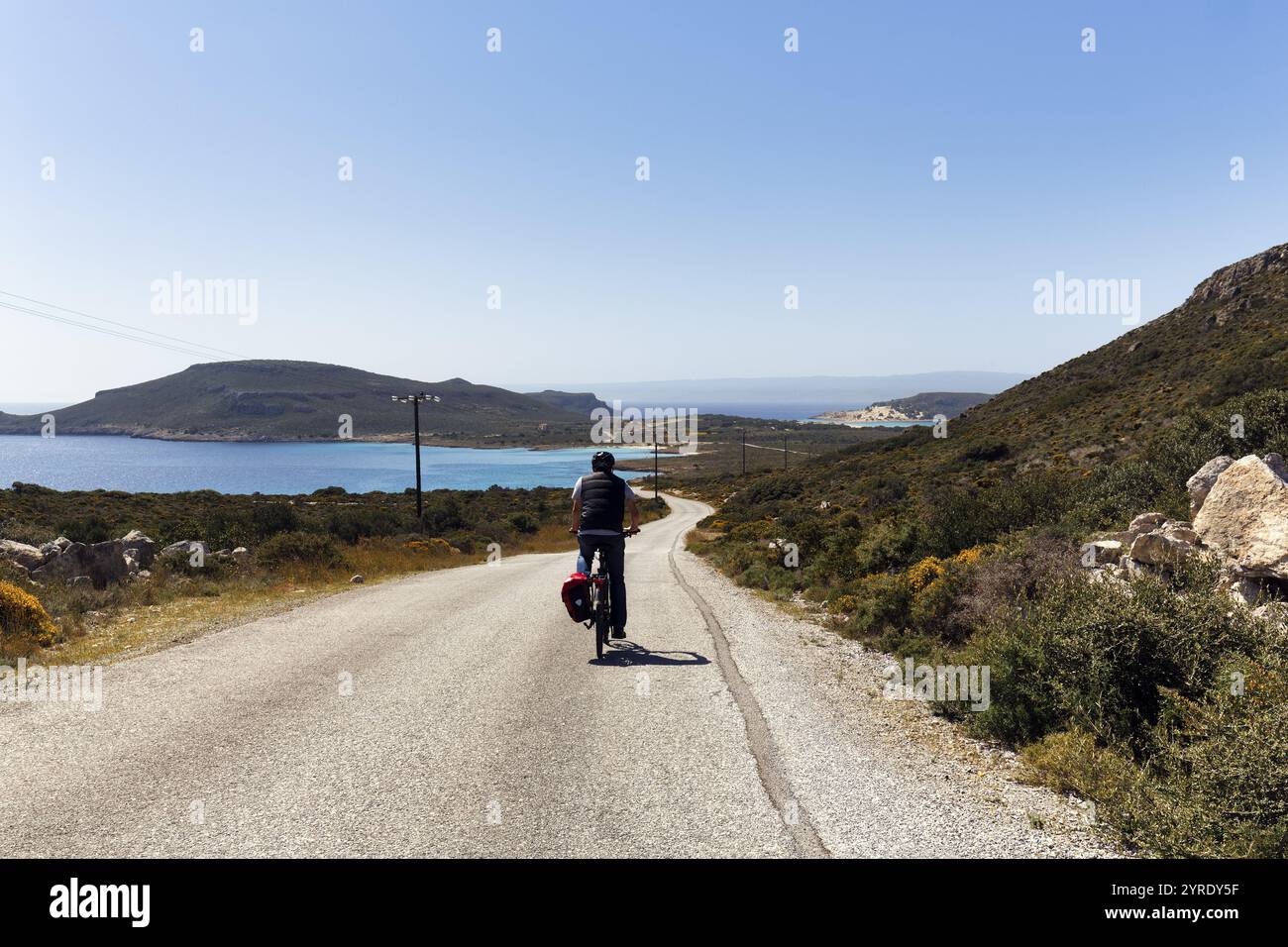 E-bike cycle tour, Bestager enjoys view of coastline, insider tip, Elafonisos, Deer Island, Laconia, Peloponnese, Ionian Islands, Ionian Sea, Greece, Stock Photo