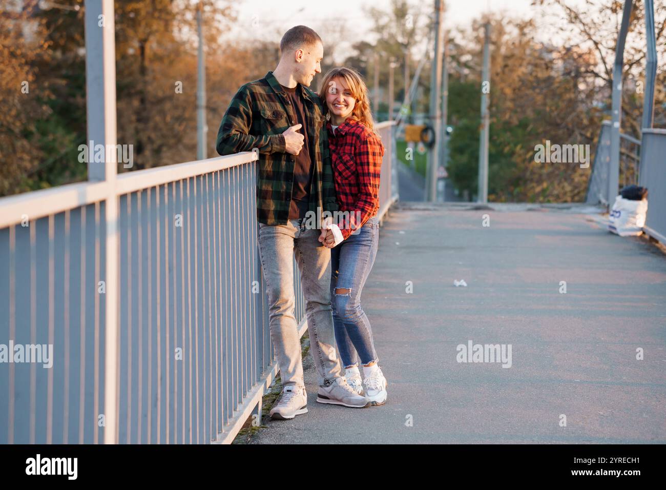 A Romantic Sunset Embrace on a Scenic Bridge Stock Photo - Alamy