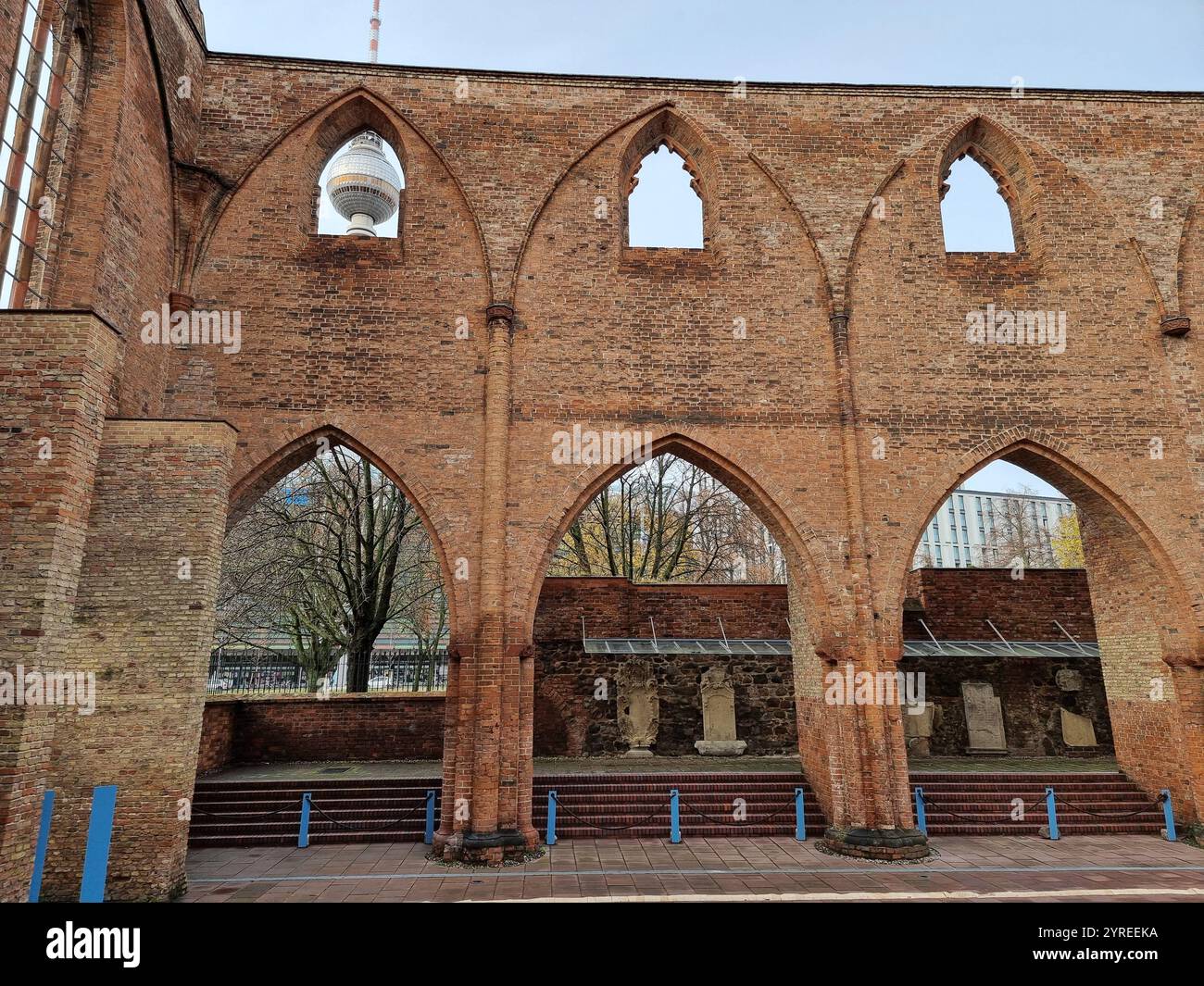 Berlin tower (Fersehturm) seen through arch in ruins of the Franciscan minster (monastery); remains of a medieval cloister culture in Berlin, Germany - Smartphone Captured Stock Image