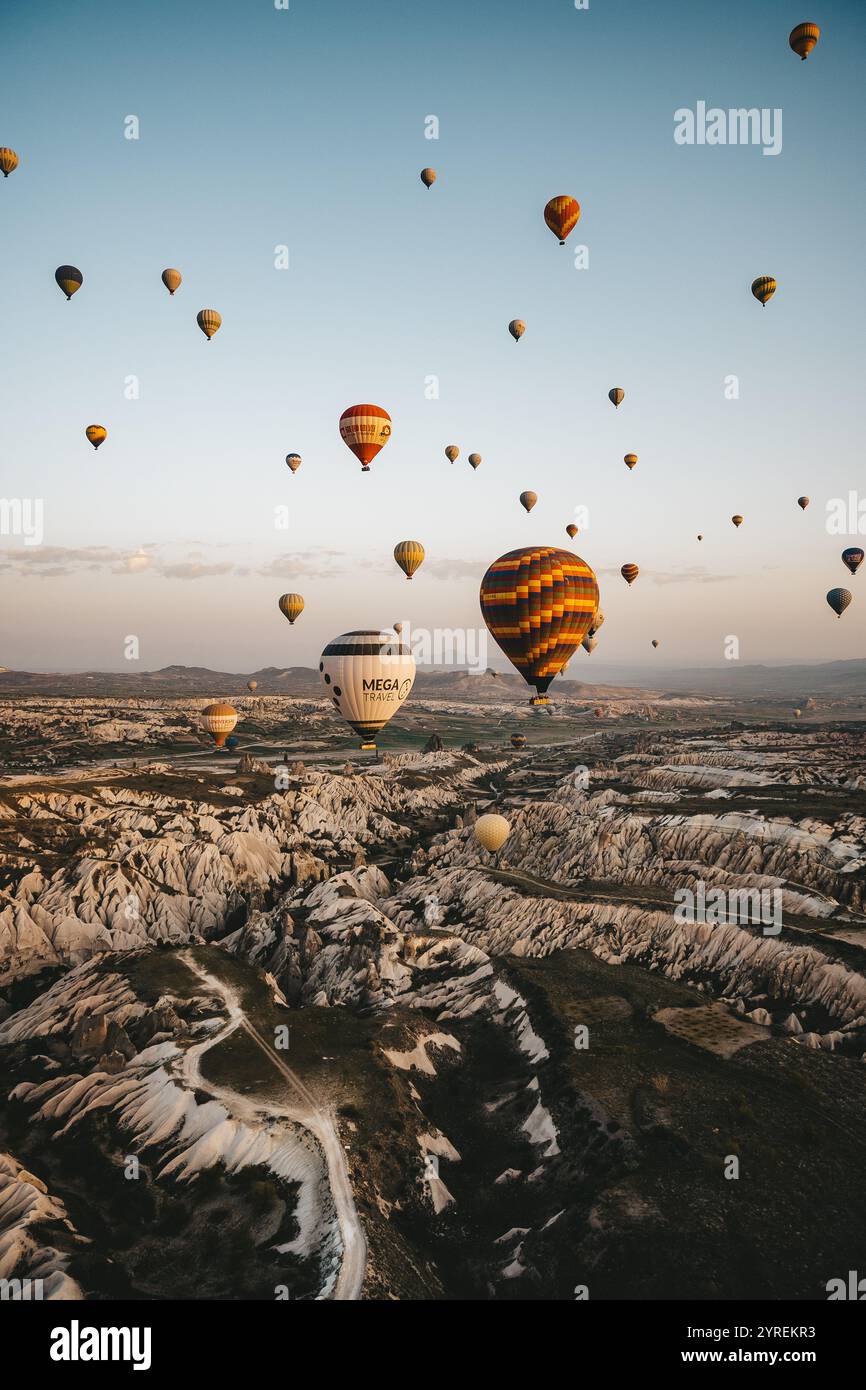 A hot air balloon floats over the stunning landscape of Cappadocia ...