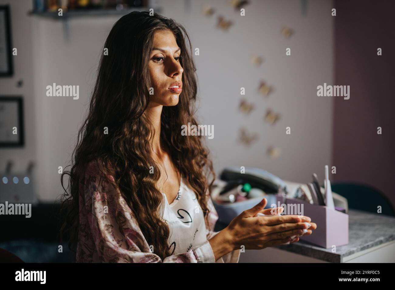 Thoughtful woman with long hair in a cozy interior setting Stock Photo ...