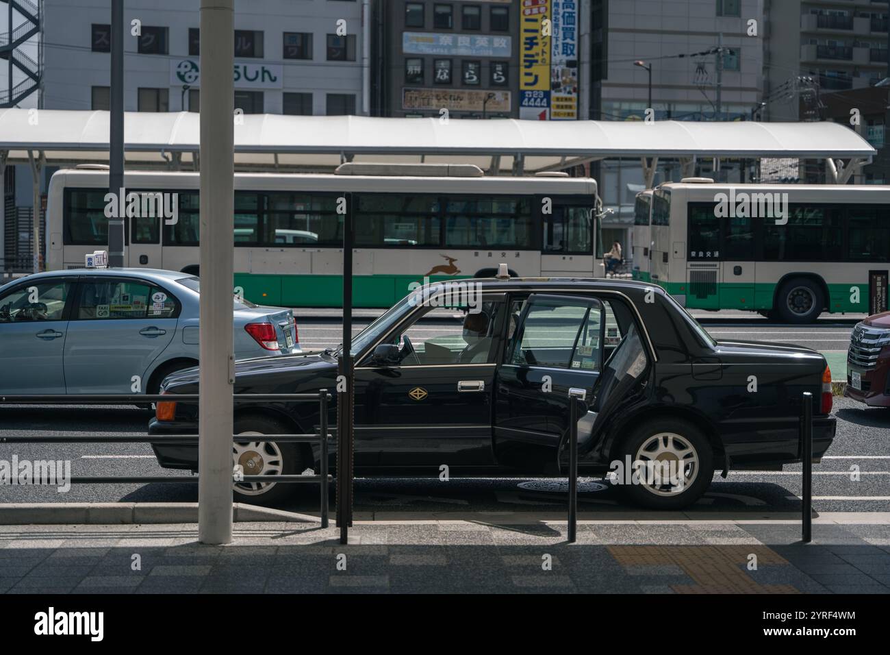 A parked cab waits at a train station in Japan, capturing a quiet moment in urban transportation and daily life. Stock Photo