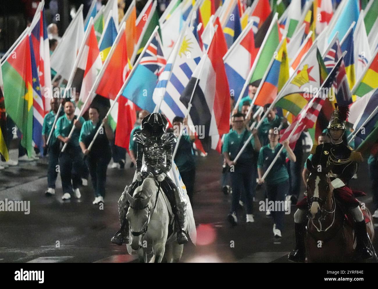 Paris, France. 26th July, 2024. The Olympic flag arrives on horseback ...