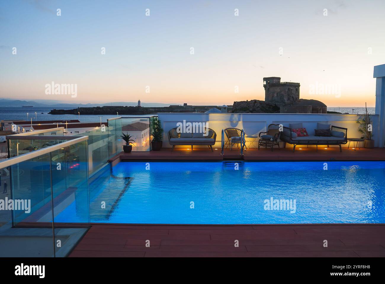 Luxurious Rooftop Pool at Sunset with Historic Tower and Sea View Stock ... - High End Rooftop Pool With Private Outdoor Movie Screen And Gourmet Grill