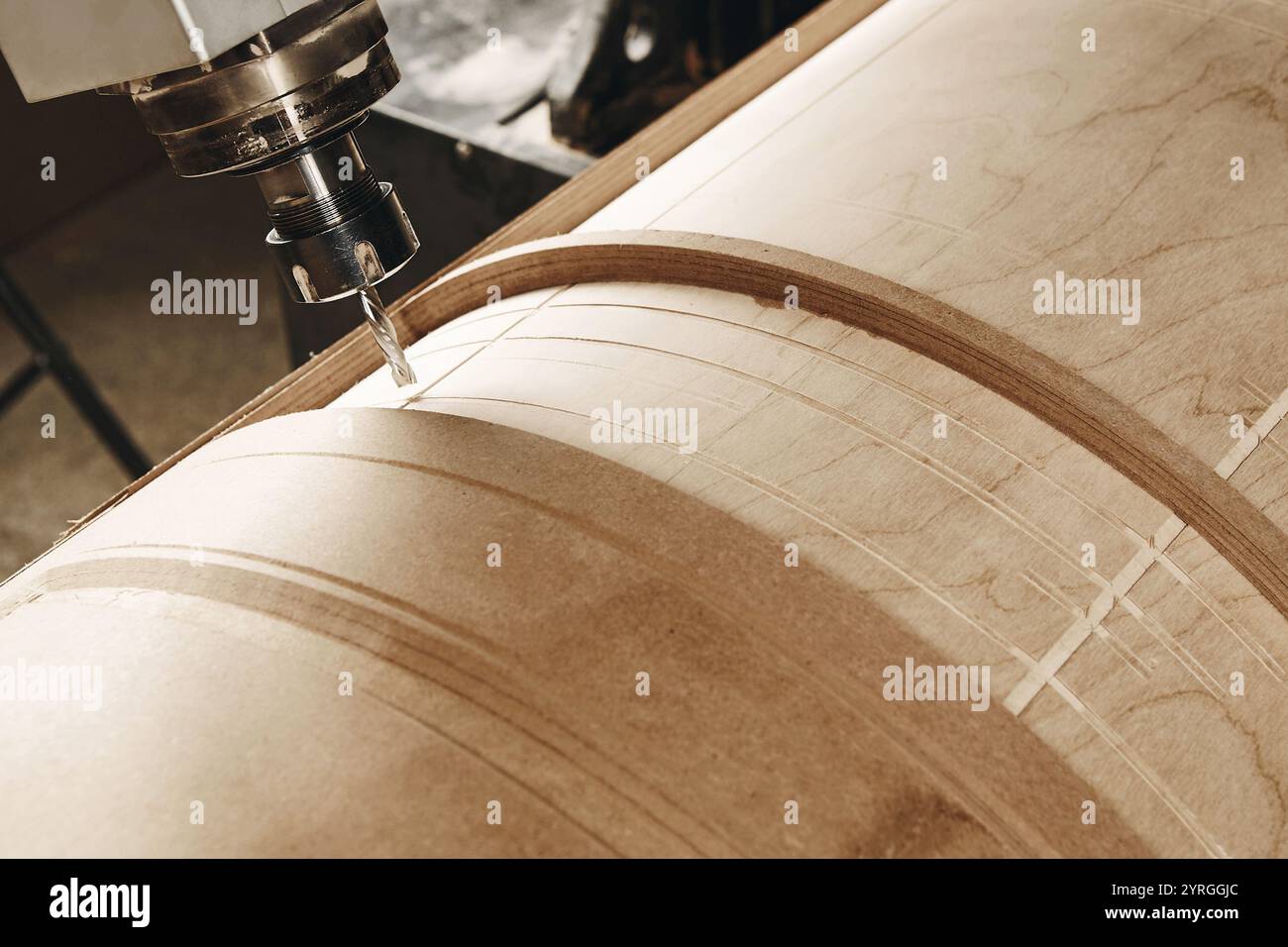 four-axis numerically controlled woodworking machine cuts out complex lines on the canvas. CNC, computer control. Stock Photo