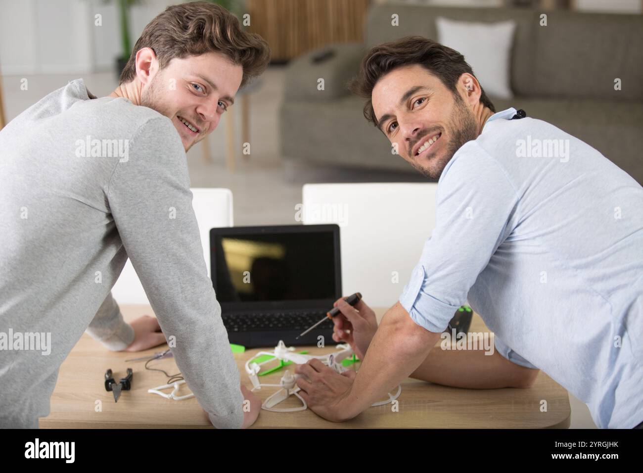 father and son playing with a small quadrocopter drone Stock Photo - Alamy