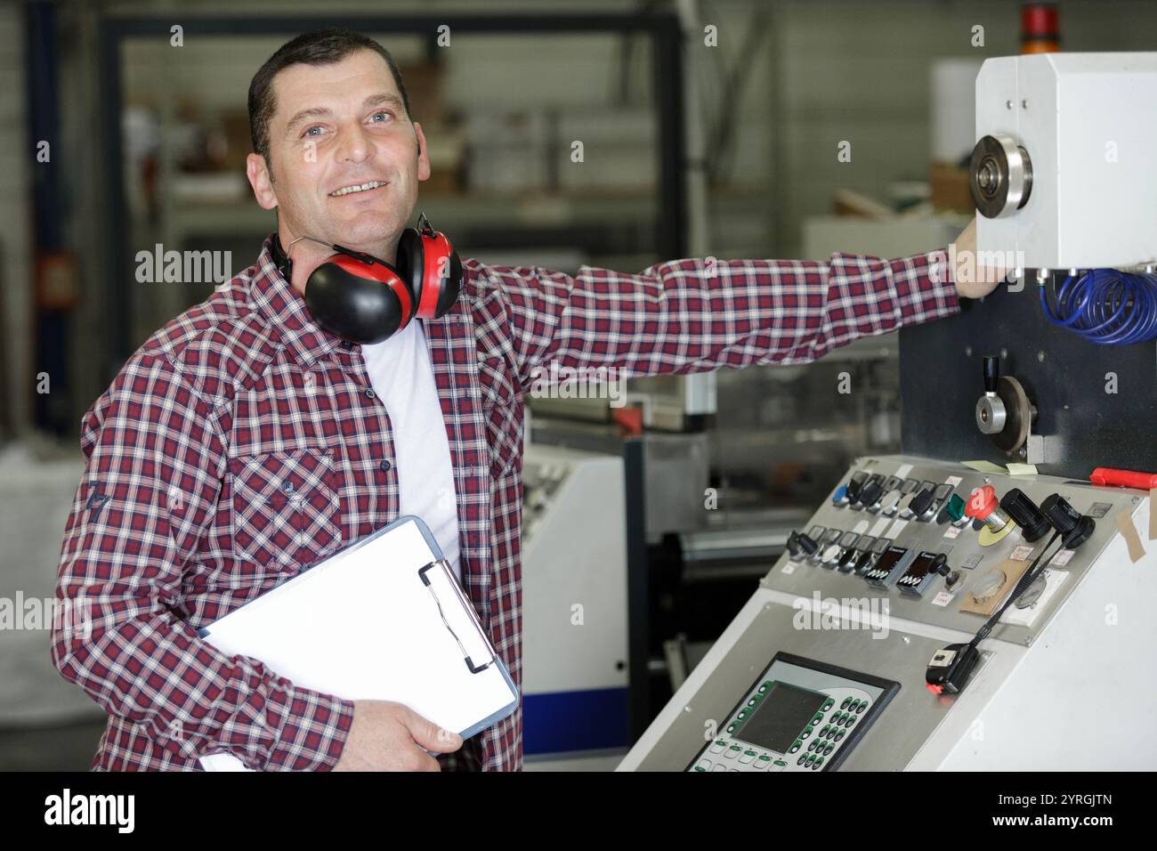 engineer presses a button in a factory Stock Photo - Alamy