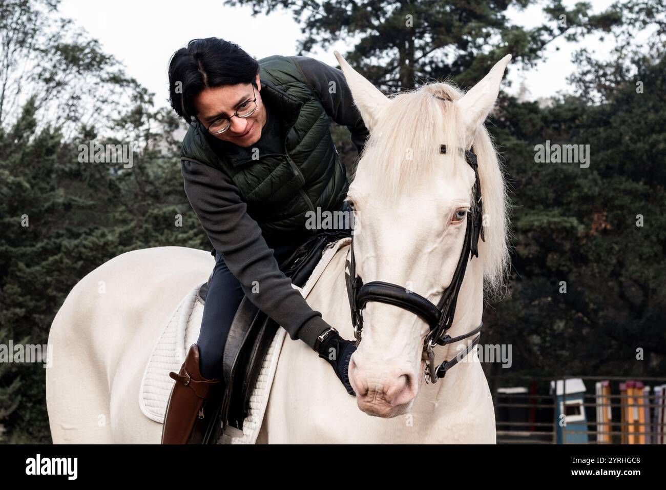 A person riding a white horse, showcasing a bond between human and ...