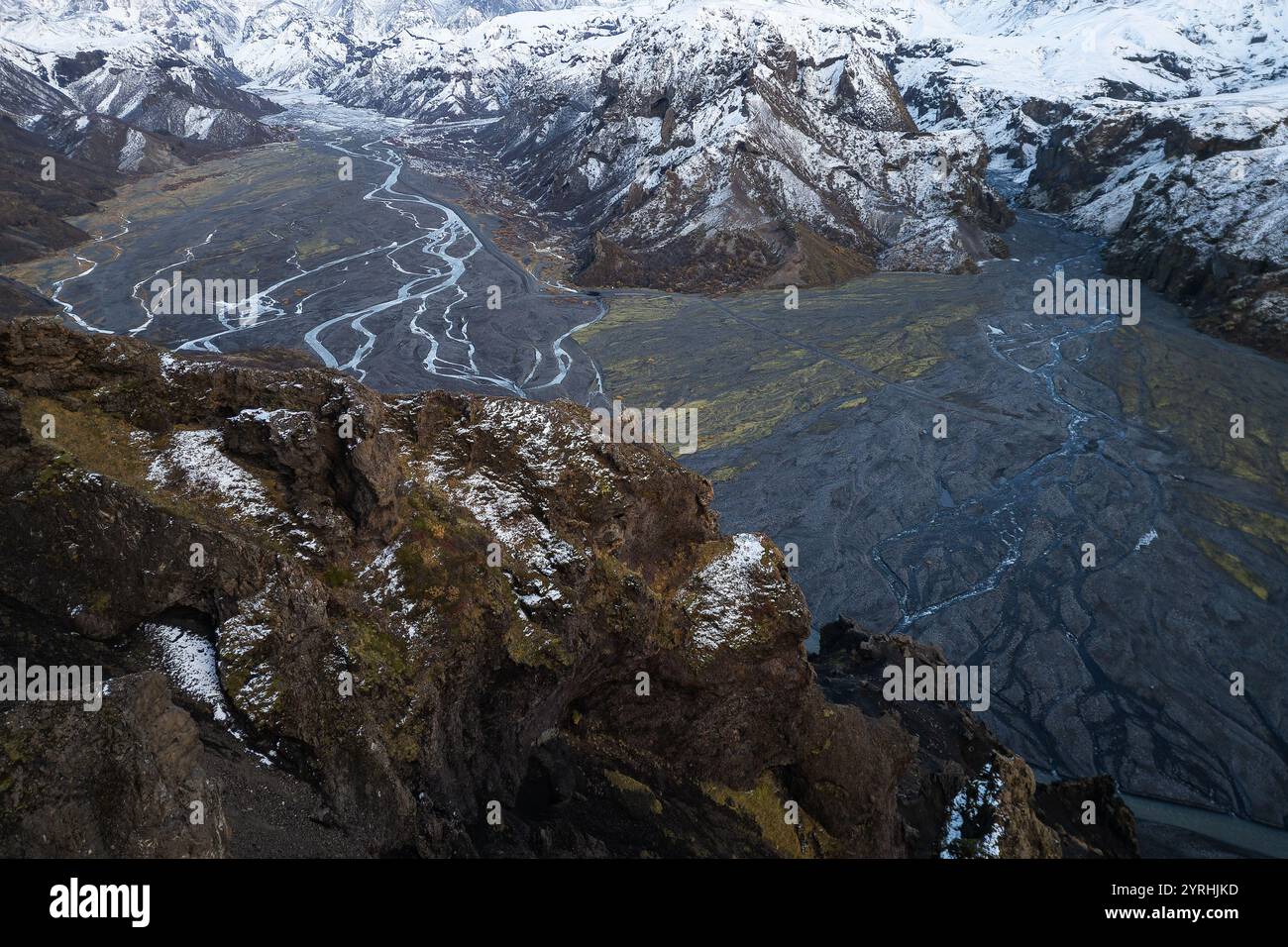 Breathtaking aerial view of a glacial river cutting through a rugged ...