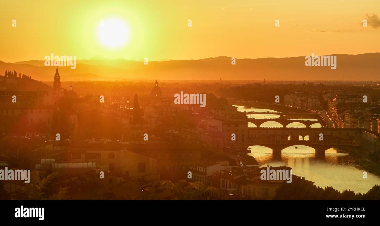 A stunning sunset bathes a historic city in golden light, highlighting ...