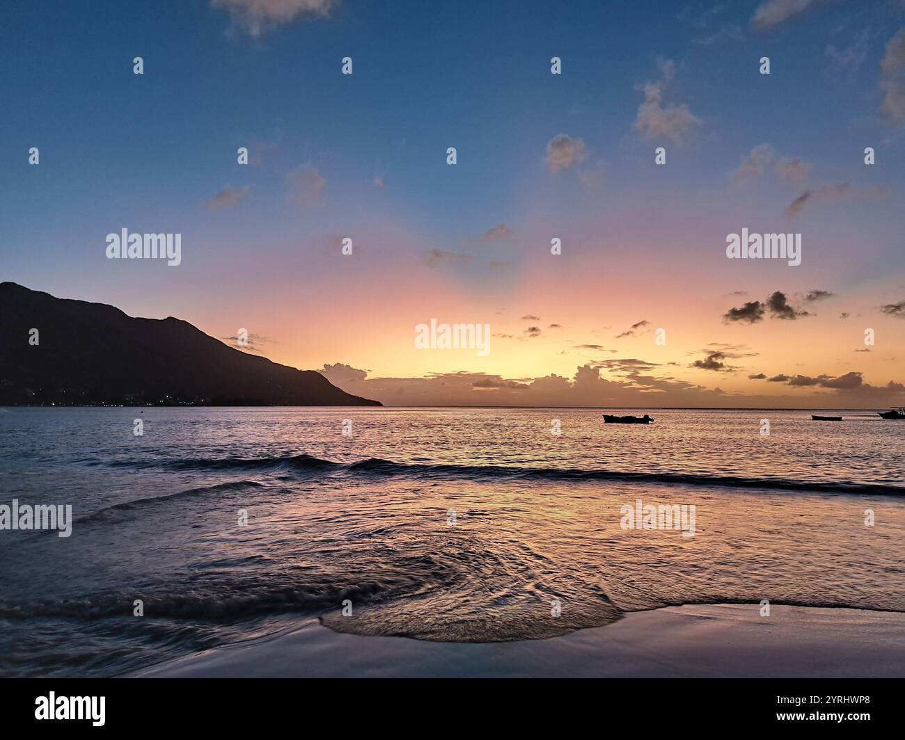 Sunset on the beach in Mahé, Seychelles. Stock Photo