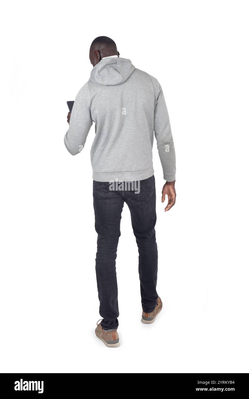 Man Using Mobile Back View back view of a man walking and looking at smartphone on white ...
