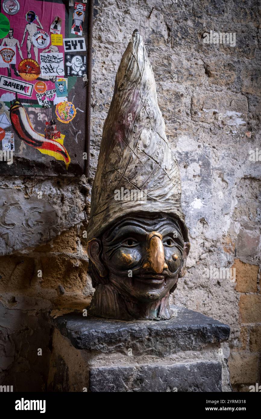 Statue with the face of Pulcinella in Via Tribunali in the old town of Naples, Italy Stock Photo