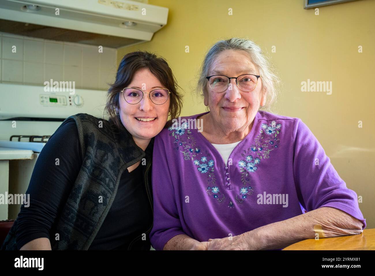 Grandmother and granddaughter sitting close together while posing for the camera in Ludington, Michigan, USA. Stock Photo