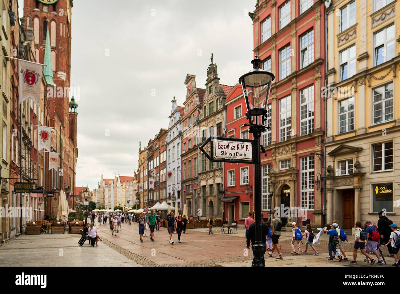 A street sign pointing to St. Mary's Church in Gdańsk, Poland, with a ...