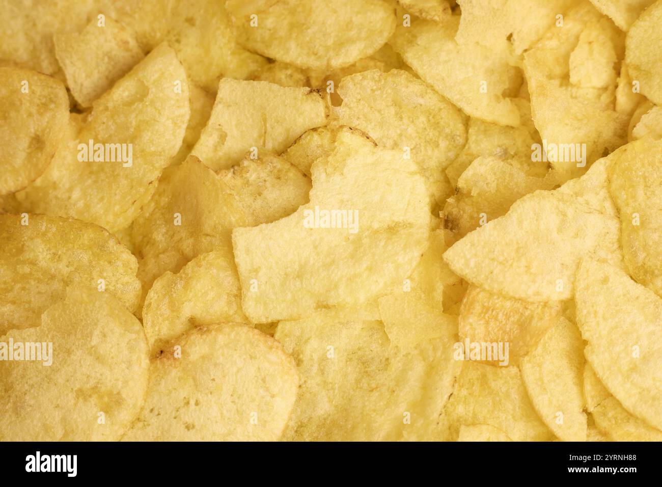 A closeup image showcasing the delightful, crispy, and crunchy texture of potato chips Stock Photo
