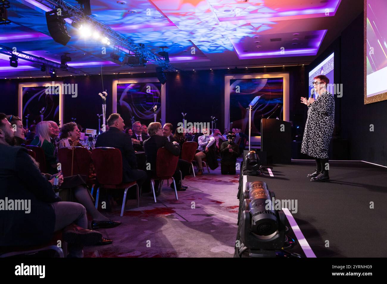 Jo Brand speaking in a microphone to a large room of people having ...
