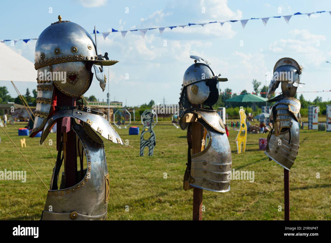 A collection of shiny metallic armor stands proudly on display in a ...