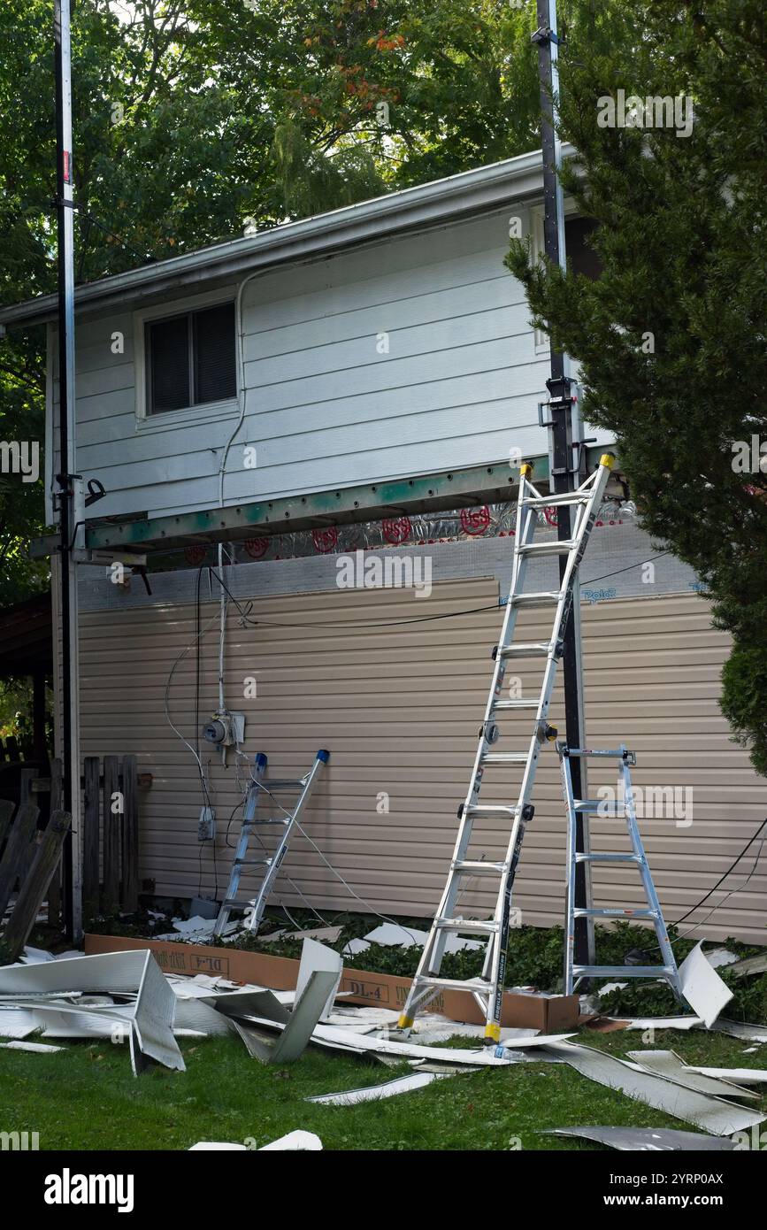 Home siding replacement in progress with three stages visible on one side.l Stock Photo