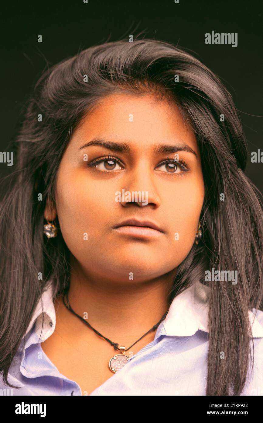 Portrait of a young indian woman with long dark hair and brown eyes ...