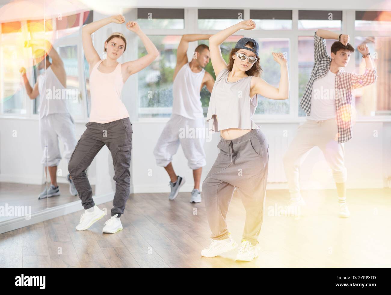 Hip-hop dance performed by group of young dancers in dance studio Stock Photo