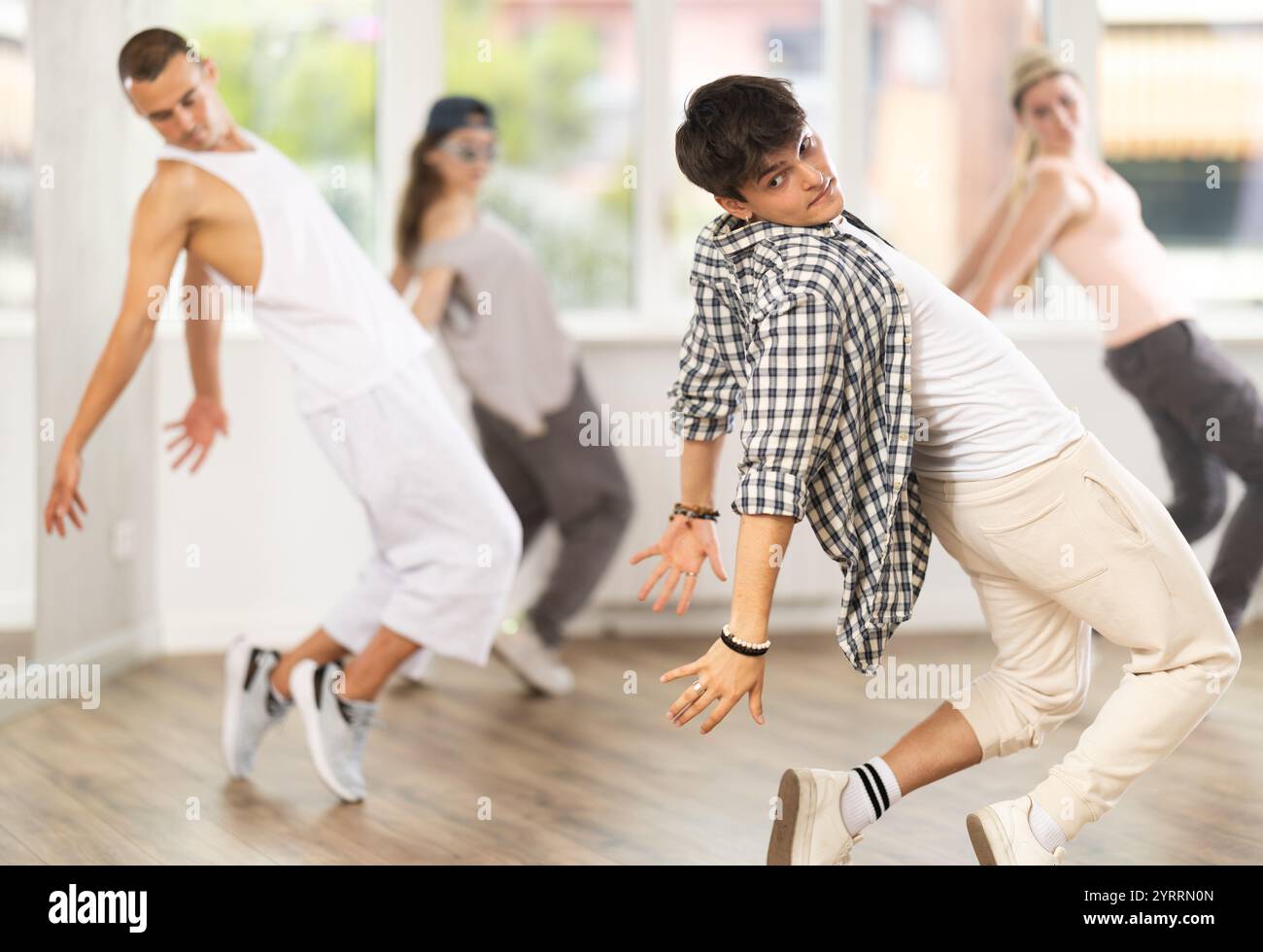 Group of young hip-hop dancers rehearsing in studio. Dancers full of ...