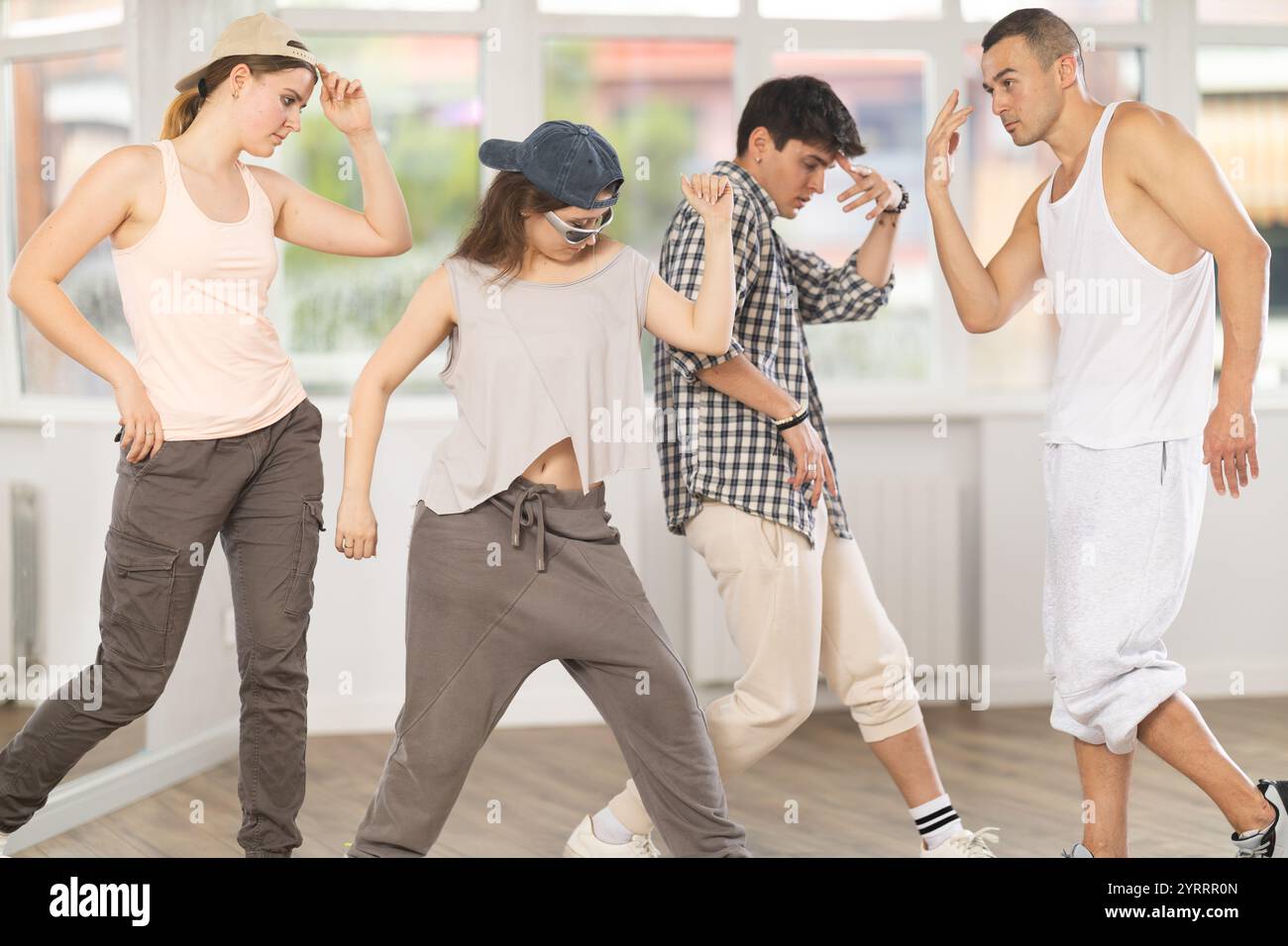 Group of young hip-hop dancers rehearsing in studio. Dancers full of ...