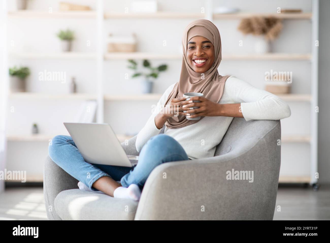Domestic Leisure. Black Muslim Lady Relaxing At Home With Laptop And ...