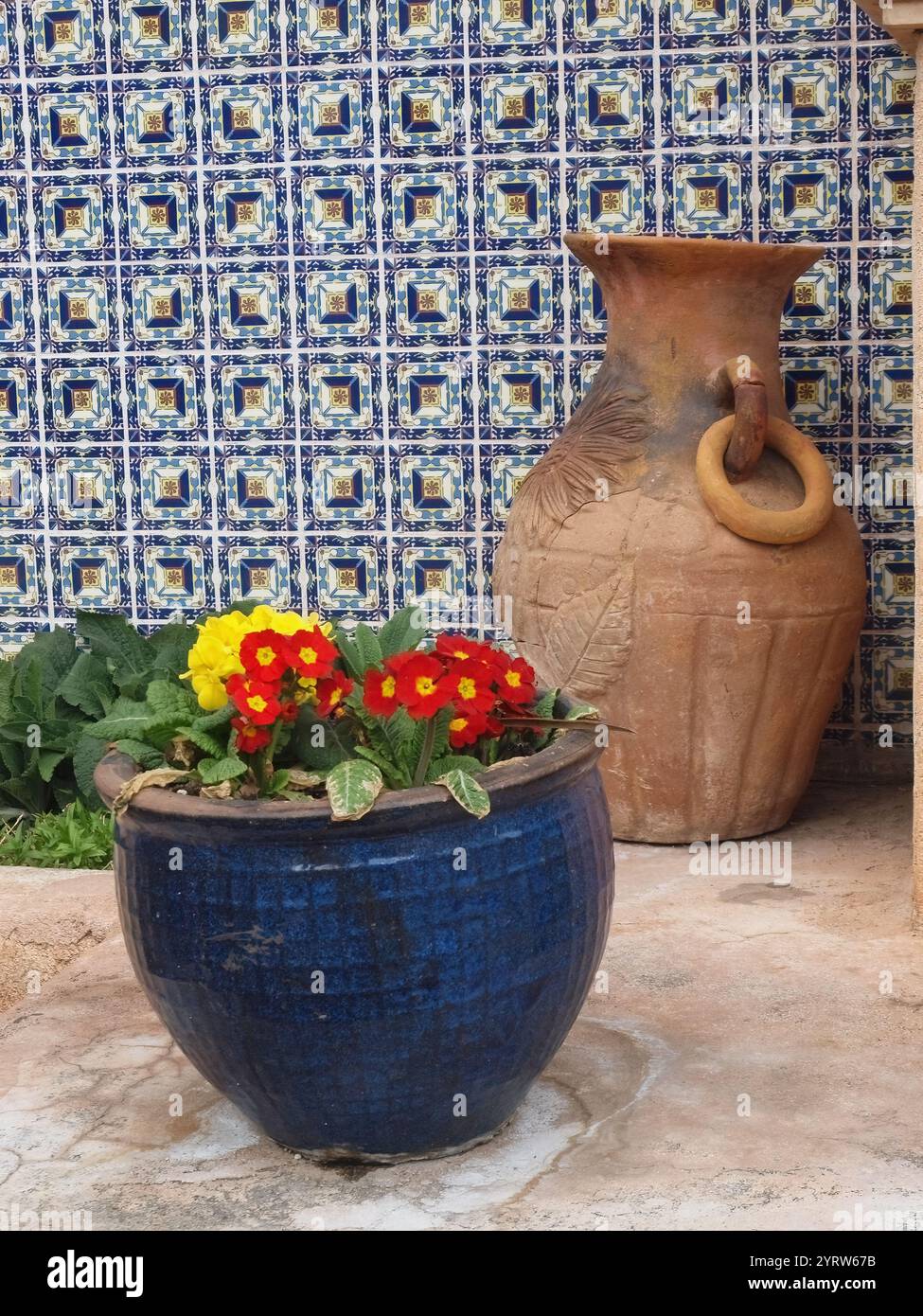 Two colorful vases and a blue patterned wall Stock Photo