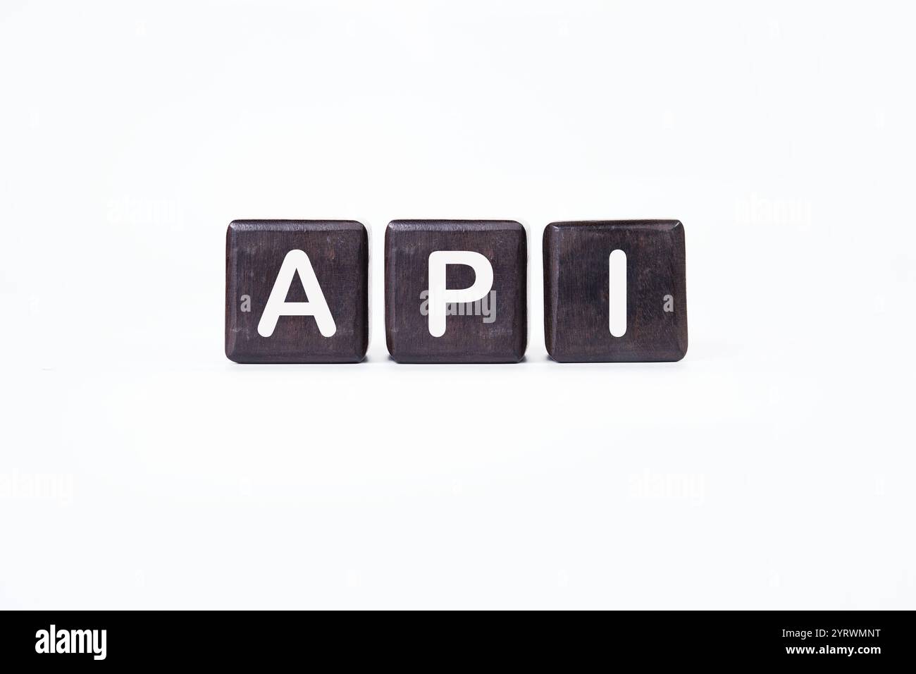 API abbreviation, modern technology concept. API It is written on dark cubes on a light background. Stock Photo