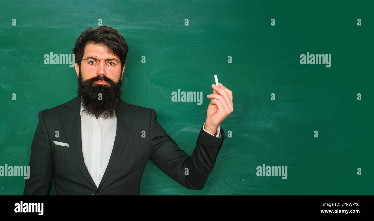 Good teachers enjoy teaching. Bearded professor at school lesson at ...