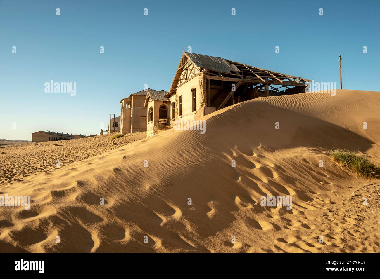 Abandoned Buildings And Sand Dunes In Kolmanskop Ghost Town By Sunny abandoned-buildings-and-sand-dunes-in-kolmanskop-ghost-town-by-sunny
