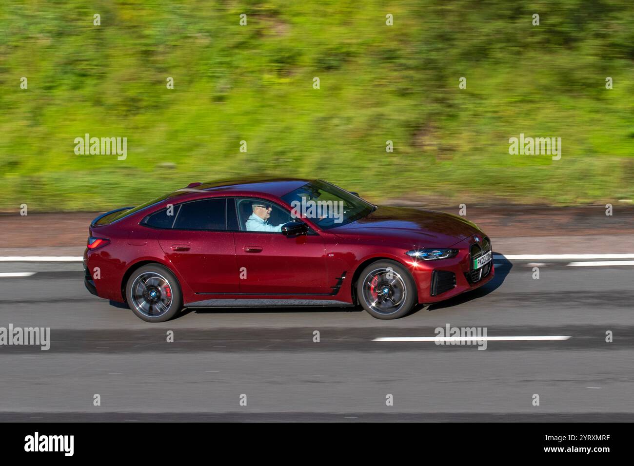 2023 Red BMW I4 M50, Base Mid-size car, Gran Coupe four-wheel drive AWD,  five-door fastback; travelling on the M6 motorway, UK Stock Photo