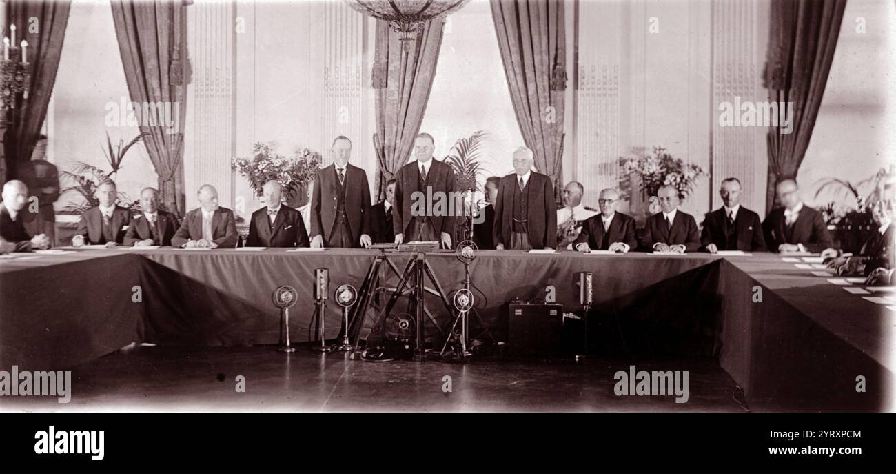 Calvin Coolidge, Herbert Hoover, and Frank B. Kellogg, standing, with representatives of the governments who have ratified the 1928 Treaty for Renunciation of War (Kellogg Briand Pact),  1929 Stock Photo