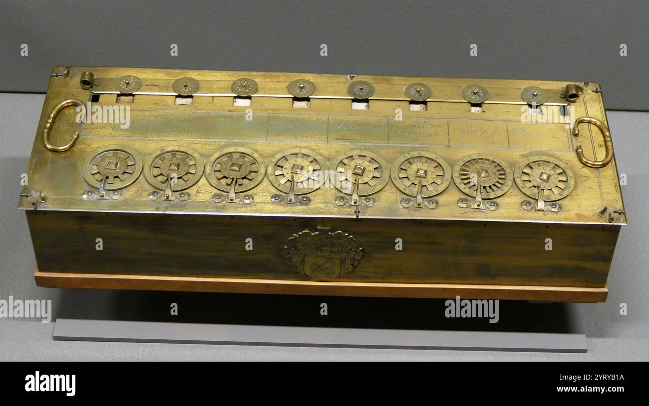 A Pascaline Calculating machine of 1652. Pascal's calculator (also known as the arithmetic machine or Pascaline) is a mechanical calculator invented by Blaise Pascal in the early 17th century. Pascal was led to develop a calculator by the laborious arithmetical calculations required by his father's work as supervisor of taxes in Rouen. He designed the machine to add and subtract two numbers directly and to perform multiplication and division through repeated addition or subtraction. Stock Photo