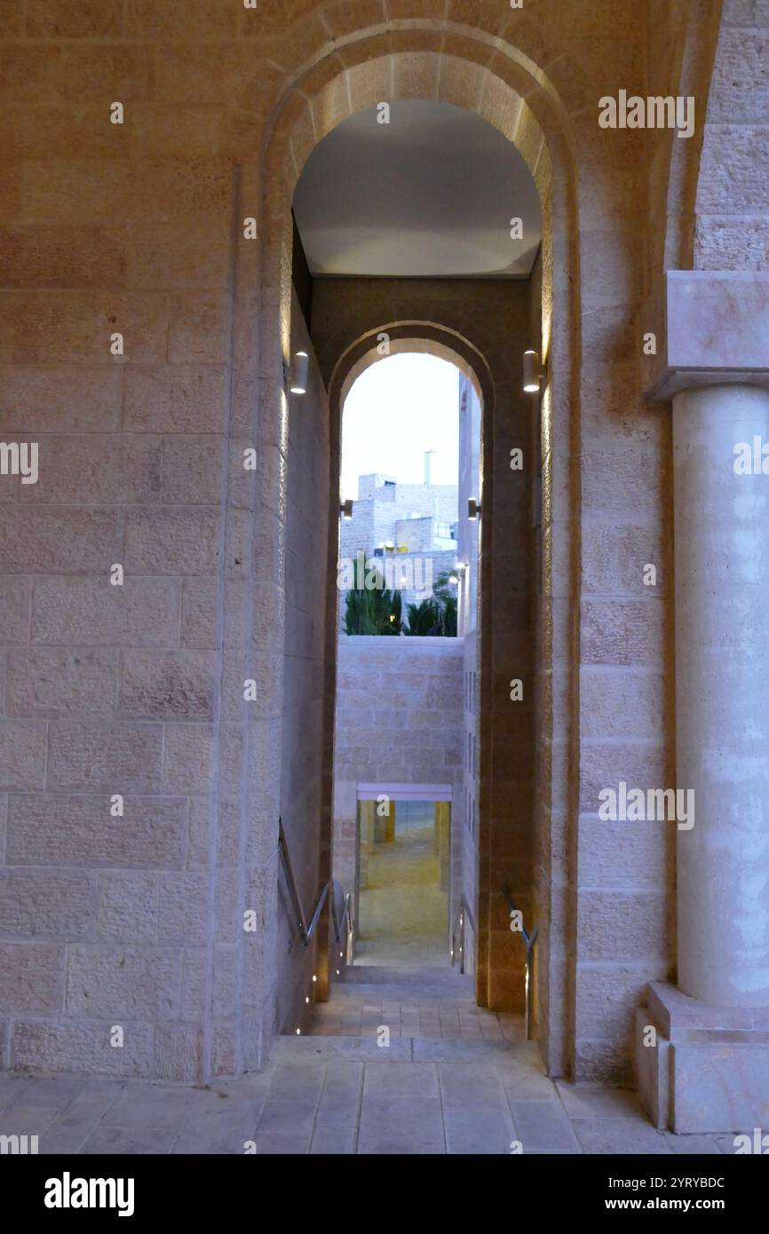 Jerusalem International YMCA. In 1924, Archibald Clinton Harte, General Secretary of the International YMCA, raised the sum of one million dollars towards the construction of the building. The cornerstone was laid in 1928 and the building opened on April 18, 1933. The building was designed by the American architect Arthur Loomis Harmon of Shreve, Lamb and Harmon, who designed the Empire State Building. Stock Photo