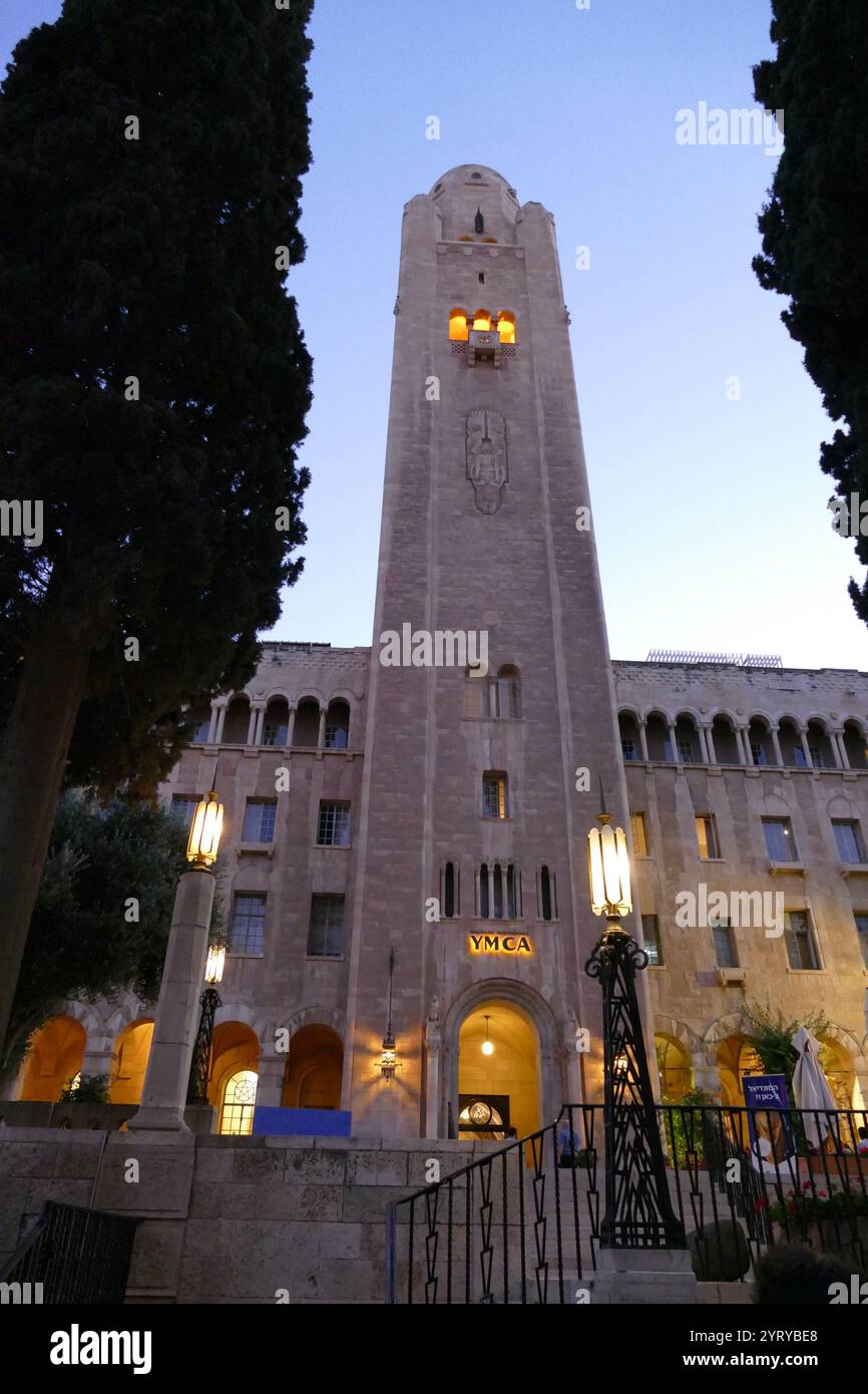 Jerusalem International YMCA. In 1924, Archibald Clinton Harte, General Secretary of the International YMCA, raised the sum of one million dollars towards the construction of the building. The cornerstone was laid in 1928 and the building opened on April 18, 1933. The building was designed by the American architect Arthur Loomis Harmon of Shreve, Lamb and Harmon, who designed the Empire State Building. Stock Photo