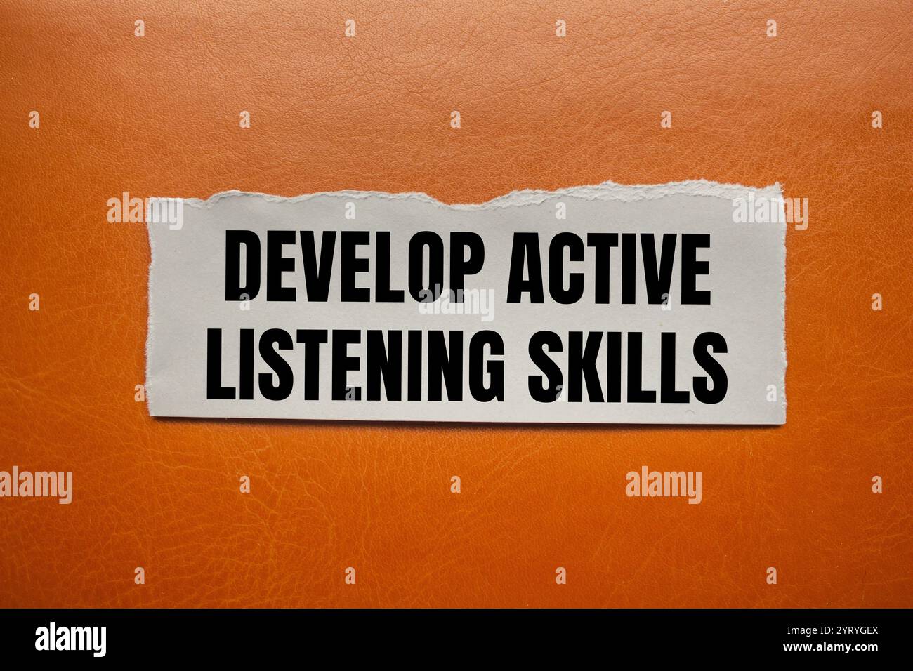 Develop active listening skills message written on ripped torn paper ...