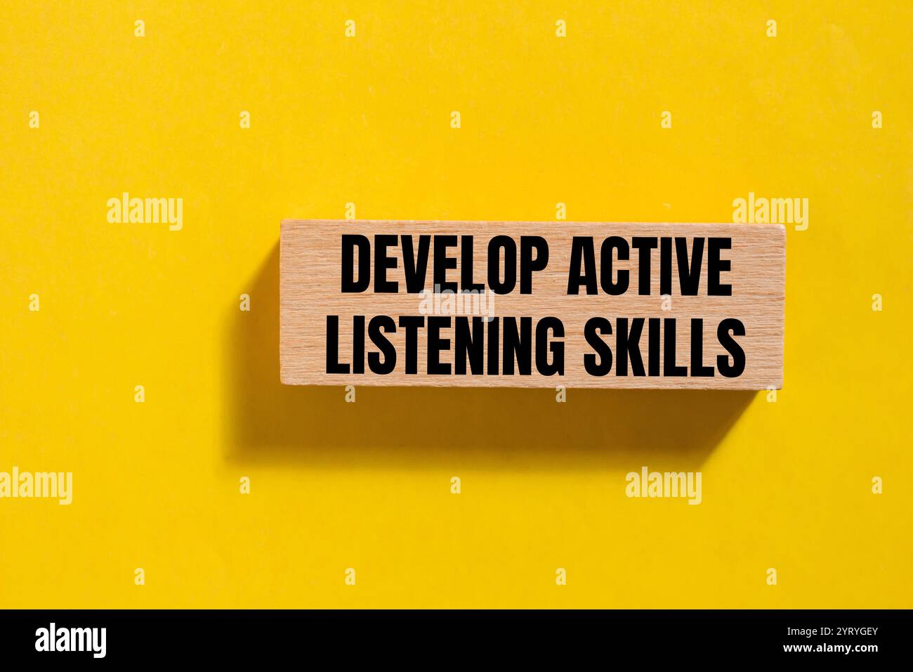 Develop active listening skills message written on wooden block with ...