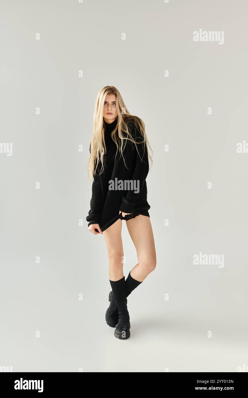 A stunning young woman with long blonde hair poses in elegant black ...