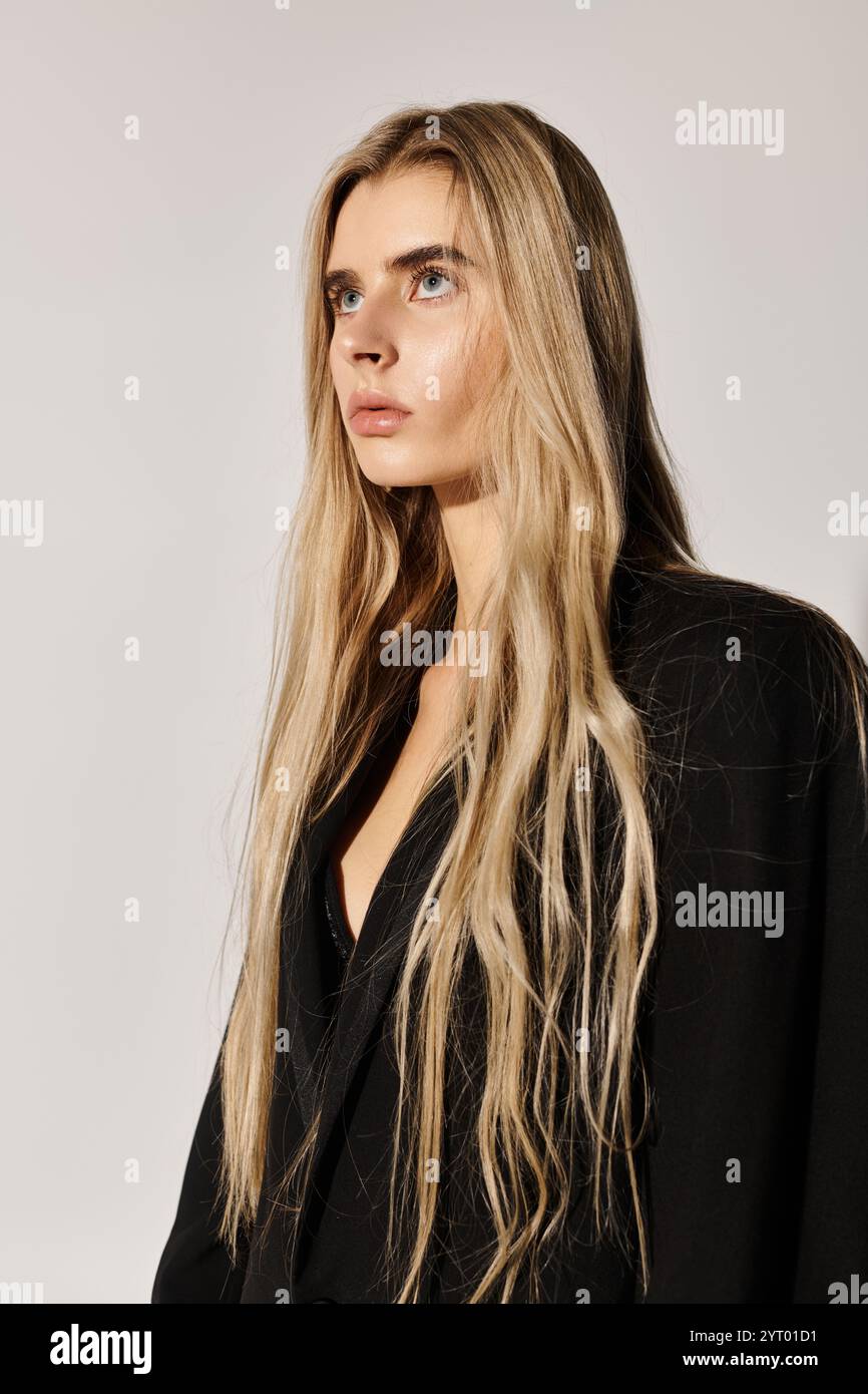 A stunning young woman with long blonde hair showcases fashion in an ...